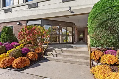 a building with a bunch of flowers in front of it at Comfort Inn Syosset-Long Island in Syosset