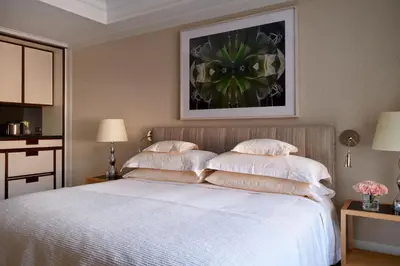 a bedroom with a white bed with two pillows at The Mark New York in New York