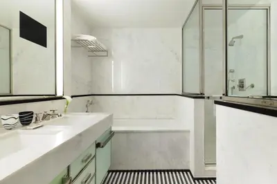 a white bathroom with a tub and a sink at The Mark New York in New York