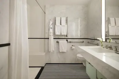 a bathroom with a tub and a sink and a toilet at The Mark New York in New York