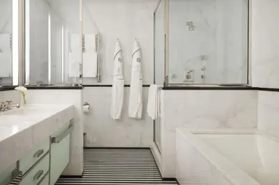 a white bathroom with a tub and a sink at The Mark New York in New York