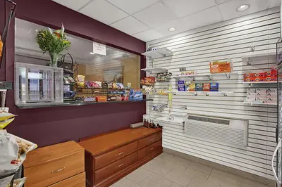 a grocery store aisle with a counter and a grocery storeacistacistacistacistacist at Ramada by Wyndham East Orange in East Orange