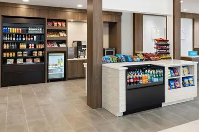 a store with a counter with drinks on it at Hilton Garden Inn Milford in Milford