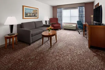 a living room with a couch and a table at Hilton Garden Inn Milford in Milford