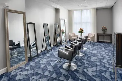 a salon with a row of chairs and mirrors at Courtyard Shelton in Shelton
