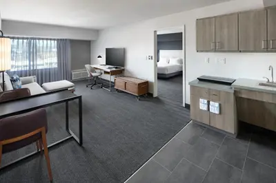 a hotel room with a kitchen and a bedroom at Courtyard Shelton in Shelton