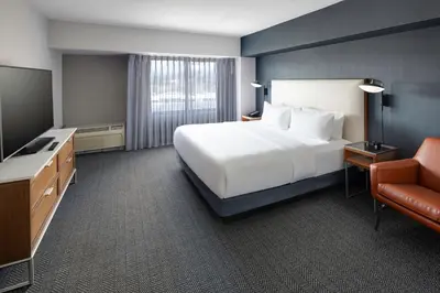 a hotel room with a bed and a television at Courtyard Shelton in Shelton