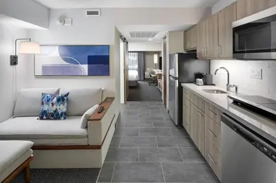 a living room with a couch and a kitchen at Courtyard Shelton in Shelton