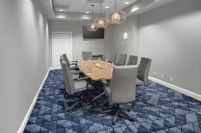 a conference room with a wooden table and chairs at Courtyard Shelton in Shelton