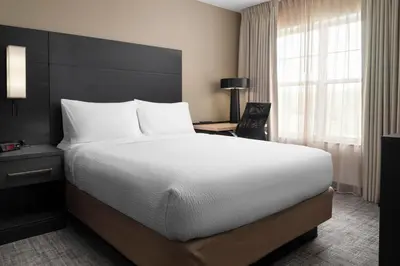 a hotel room with a large bed and a window at Residence Inn Mount Olive At International Trade Center in Stanhope