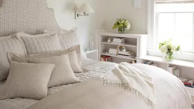 a bedroom with a white bed with pillows and a window at 33 Main in Lenox