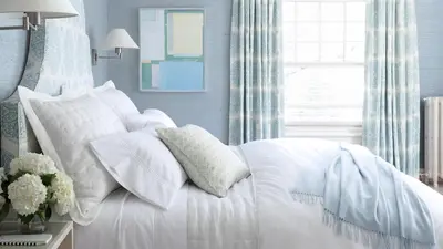 a white bed with white pillows and a window at 33 Main in Lenox