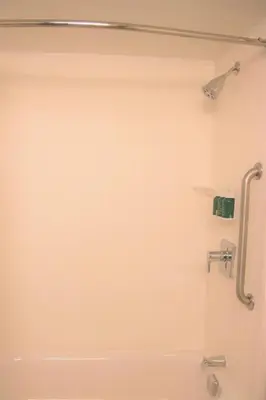 a bathroom with a shower and a bath tub at Courtyard Waterbury Downtown in Waterbury