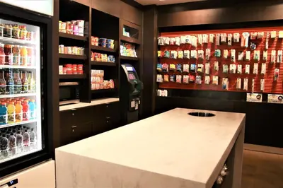 a bar in a store with a drink refrigerator at Courtyard Waterbury Downtown in Waterbury