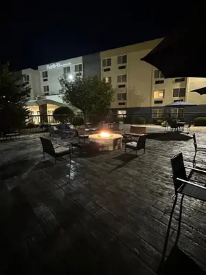a courtyard with benches and a fire pit at night at Fairfield by Marriott Inn & Suites Wallingford New Haven in Wallingford