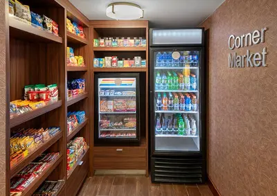 a store aisle with a soda refrigerator in a store at Fairfield by Marriott Inn & Suites Wallingford New Haven in Wallingford