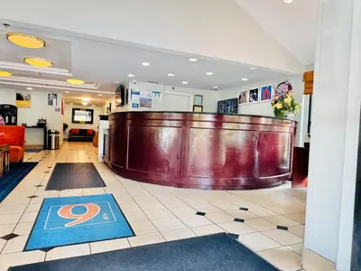 a hotel lobby with a bar in the center at Motel 6-Milford, CT in Milford