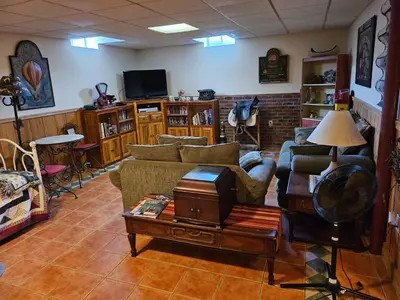 a living room with a couch and a table at Clover Hill Farm & Country Inn in Williamstown