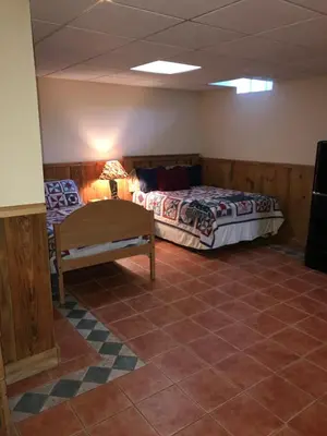 a room with a bed and a bench in it at Clover Hill Farm & Country Inn in Williamstown
