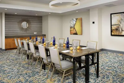 a conference room with a long table and chairs at Hilton Garden Inn Westchester Dobbs Ferry in Dobbs Ferry