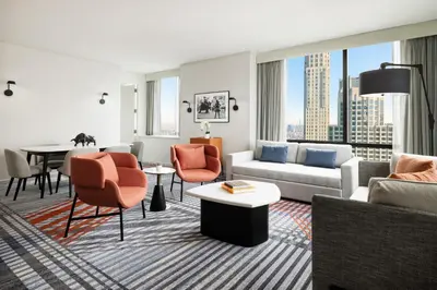 a living room with a couch and chairs and a table at M Social Hotel New York Downtown in New York