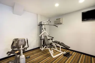 a gym with two treadmills and two exercise bikes at Quality Inn Albany Colonie in Albany