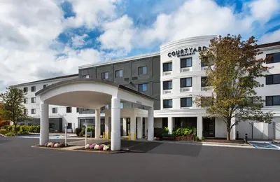 an external view of a hotel with a building at Courtyard by Marriott Middletown Goshen in Middletown