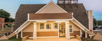 a small house with a gambrel roof at Vernon Motel in Vernon