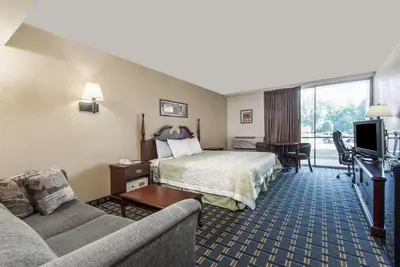 a hotel room with a bed and a couch at Vernon Motel in Vernon