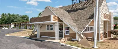 a small building with a parking lot in front of it at Vernon Motel in Vernon