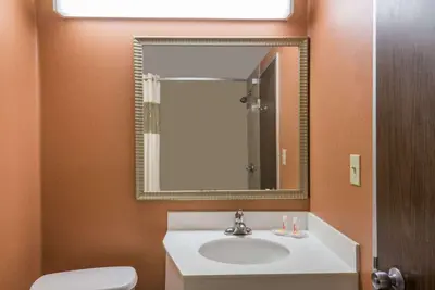 a bathroom with a white sink and a mirror at Vernon Motel in Vernon