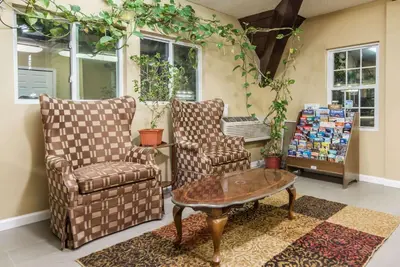 a living room with two chairs and a coffee table at Vernon Motel in Vernon