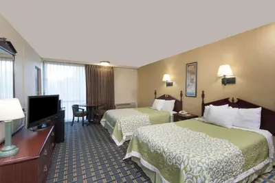 a hotel room with two beds and a flat screen tv at Vernon Motel in Vernon