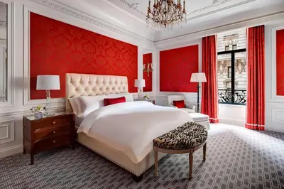 a bedroom with a large white bed and red walls at The St. Regis New York in New York