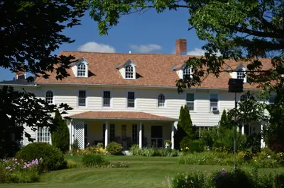 a white house with a brown roof at Harbour House Inn B&B in Cheshire