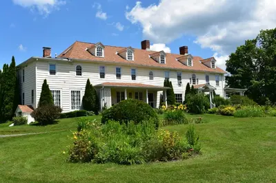 a large white house with a red roof at Harbour House Inn B&B in Cheshire