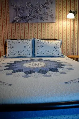 a bed with two pillows and a quilt on it at Harbour House Inn B&B in Cheshire