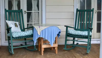 two chairs and a glass table on a porch at Harbour House Inn B&B in Cheshire