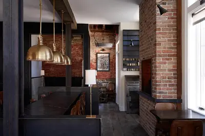 a dining room with a brick wall at Wm. Farmer and Sons in Hudson