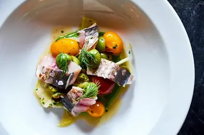 a white plate with a salad with meat and vegetables at Wm. Farmer and Sons in Hudson