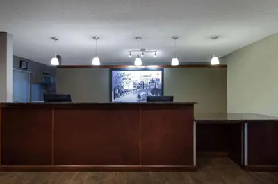 an office with a bar with a tv on the wall at Super 8 by Wyndham Cromwell/Middletown in Cromwell
