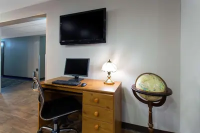 an office with a desk with a computer and a lamp at Super 8 by Wyndham Cromwell/Middletown in Cromwell