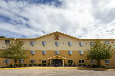 a hotel building with a sign on the front at Super 8 by Wyndham Cromwell/Middletown in Cromwell