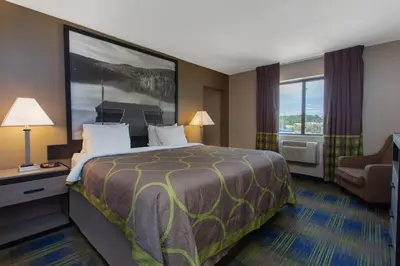 a hotel room with a bed and a window at Super 8 by Wyndham Cromwell/Middletown in Cromwell
