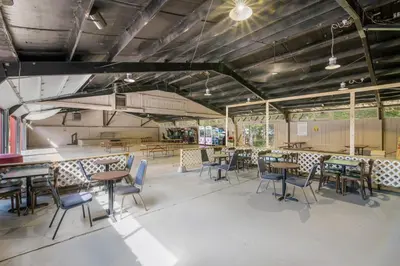 a dining room with tables and chairs in it at Rondout Valley Camping Resort Deluxe Park Model 11 in Accord