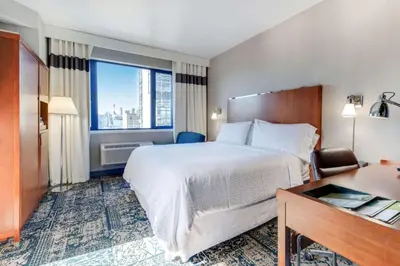 a hotel room with a large bed and a desk at Vista LIC Hotel, Premier Collection by Best Western in Queens