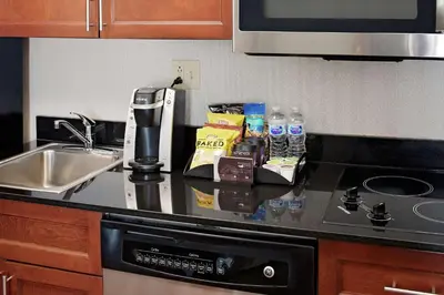 a kitchen counter top with a sink and a coffee maker at Homewood Suites by Hilton Hartford-Farmington in Farmington