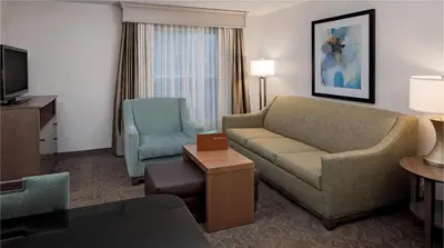 a living room with a couch and chairs in a hotel room at Homewood Suites by Hilton Hartford-Farmington in Farmington