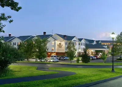 a street in a residential neighborhood with cars parked in a parking lot at Homewood Suites by Hilton Hartford-Farmington in Farmington
