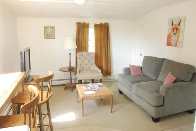 a living room with a couch and a table at Harwood Hill Motel in Bennington